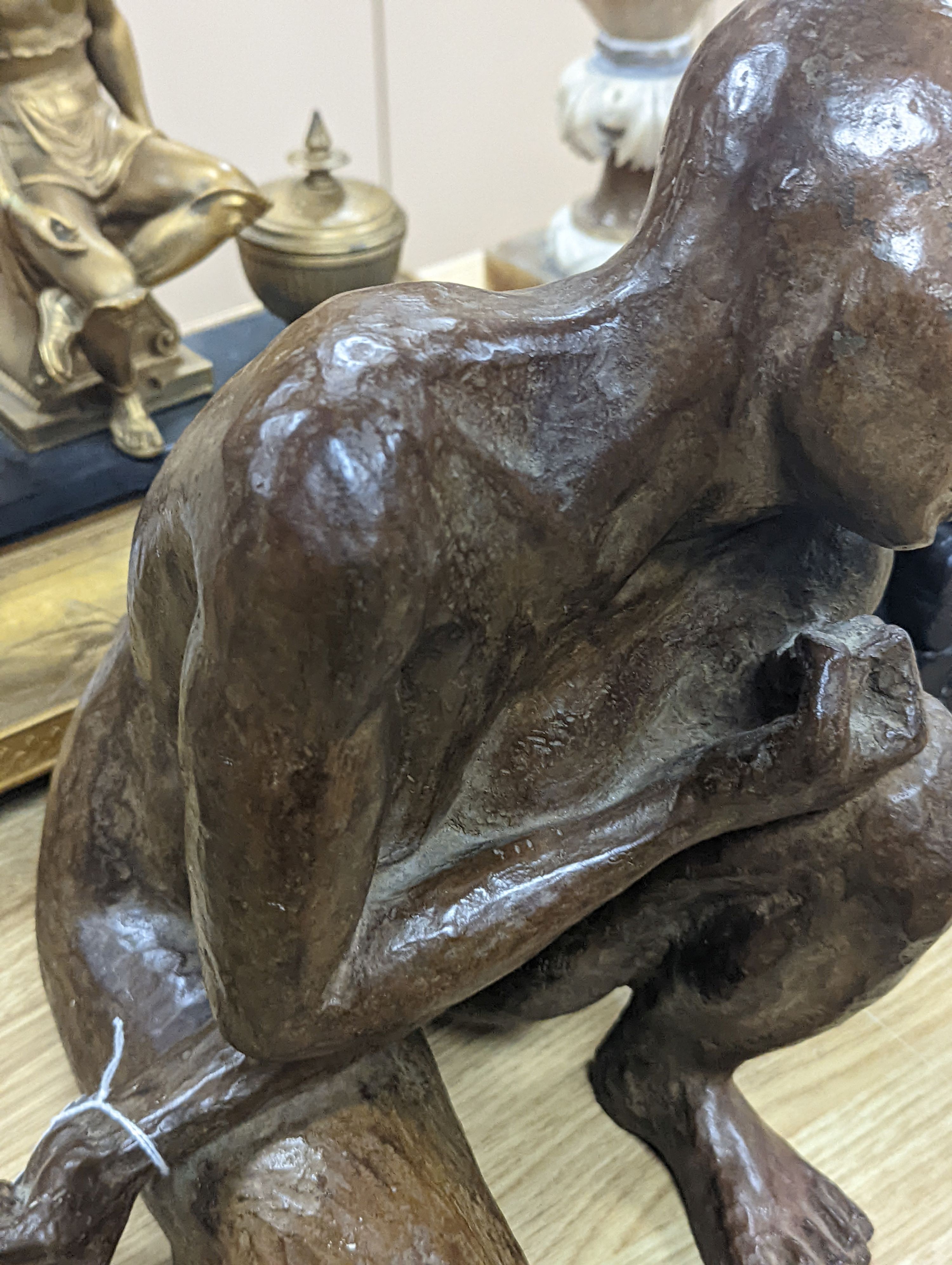 A contemporary bronze of a lady crouching with a thoughtful expression, unsigned - 31cm high